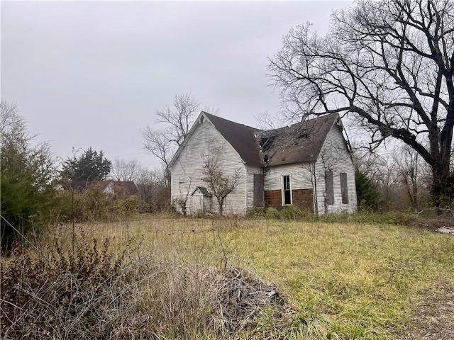 view of side of home featuring an outbuilding