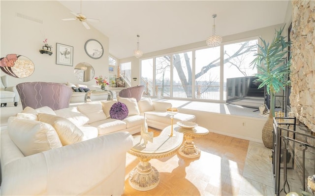 living room with a stone fireplace, ceiling fan, and lofted ceiling