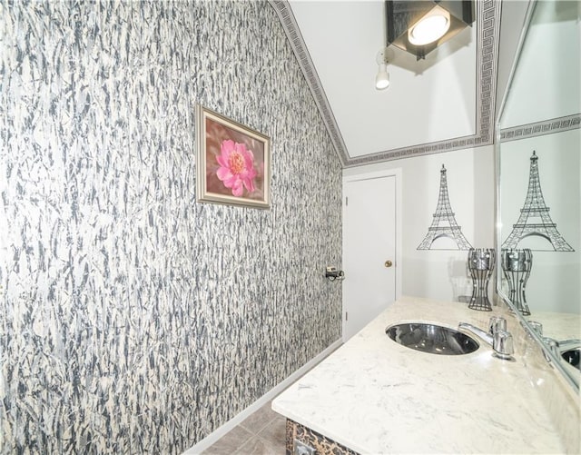 bathroom with crown molding, tile patterned flooring, and vanity