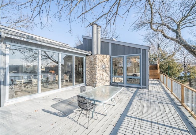 wooden terrace featuring a water view