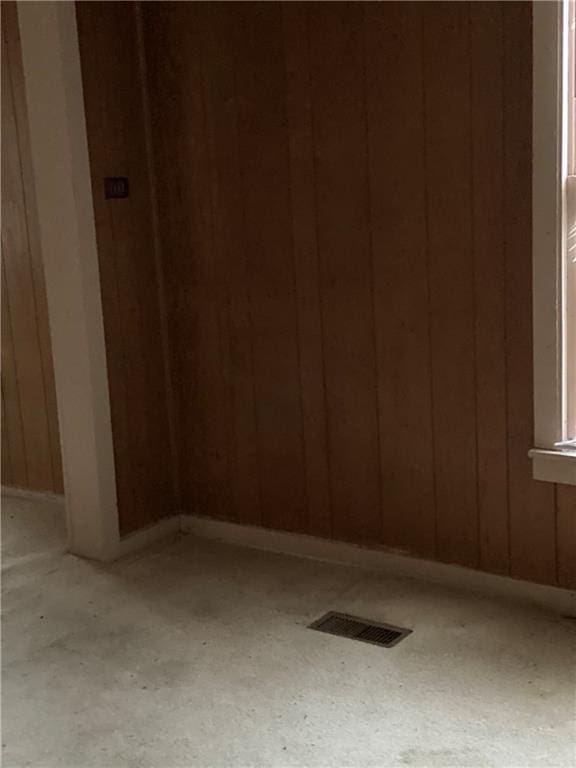 spare room with wood walls