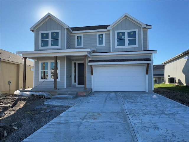 view of front of house featuring a porch, a garage, and cooling unit