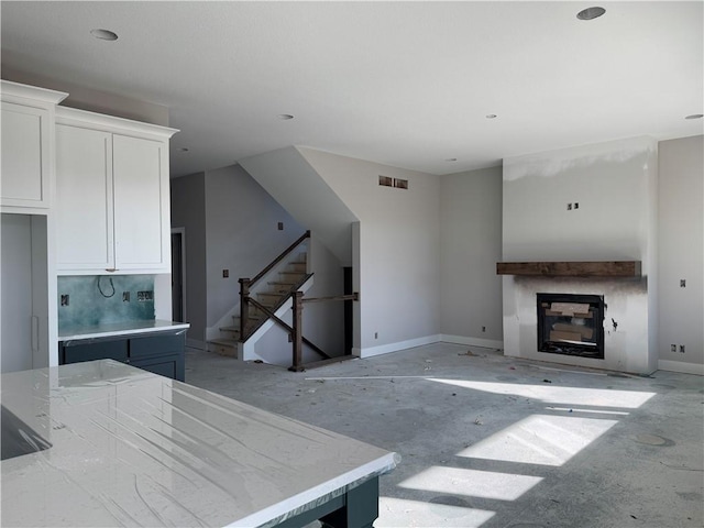 kitchen featuring white cabinets, decorative backsplash, and a kitchen island