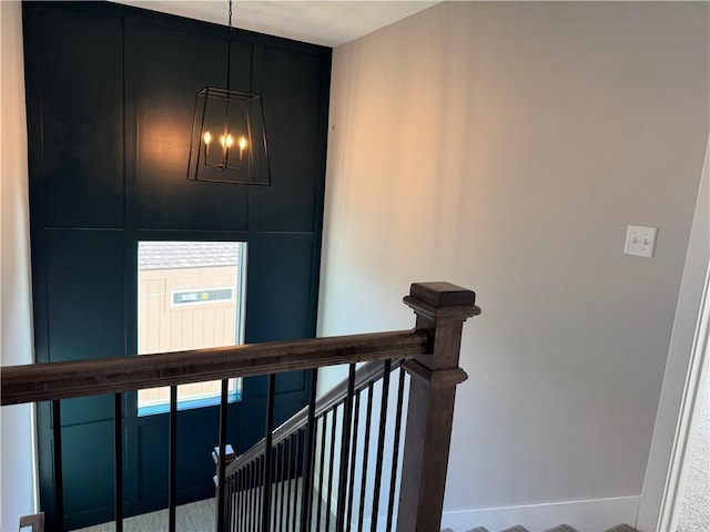 staircase featuring a chandelier