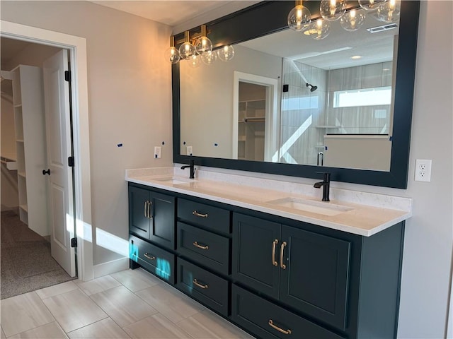 bathroom with vanity, tile patterned flooring, and a shower with door