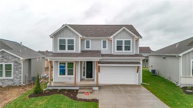 1515 SW Arbor Park Dr, Lees Summit, MO 64082 - view of front of home featuring board and batten siding, covered porch, concrete driveway, and a front yard
