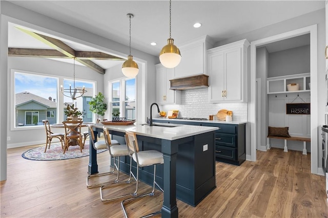 1515 SW Arbor Park Dr, Lees Summit, MO 64082 - kitchen featuring a sink, backsplash, white cabinetry, recessed lighting, and an island with sink