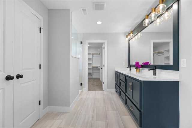 1515 SW Arbor Park Dr, Lees Summit, MO 64082 - full bathroom with double vanity, a walk in closet, baseboards, a stall shower, and recessed lighting