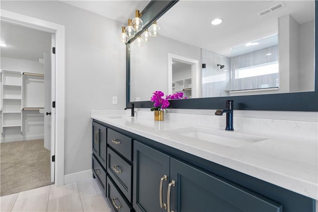1515 SW Arbor Park Dr, Lees Summit, MO 64082 - bathroom with double vanity, a walk in closet, a tile shower, tile patterned floors, and recessed lighting