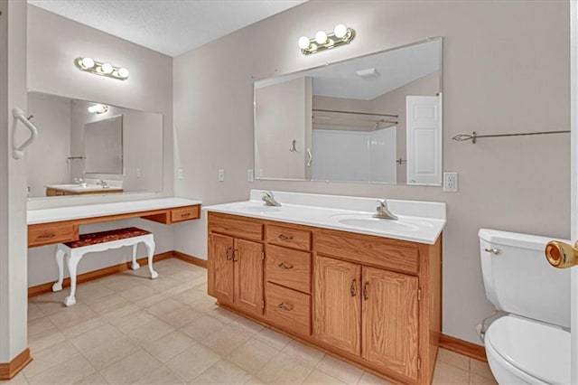 bathroom with a shower, vanity, and toilet