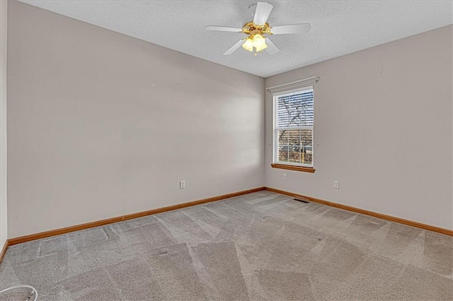 spare room with carpet, ceiling fan, and a textured ceiling