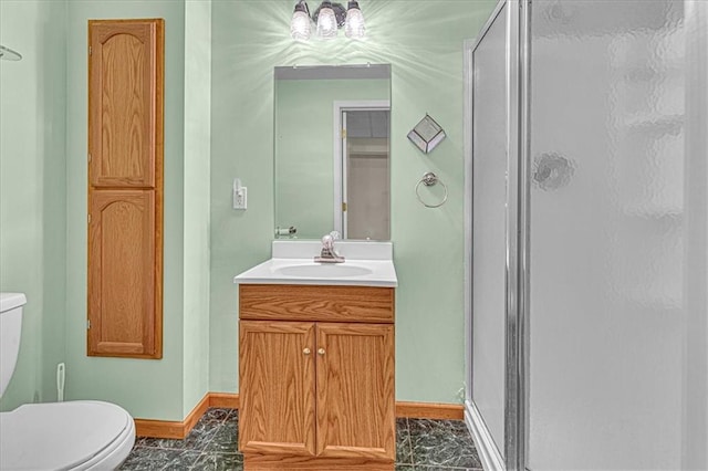 bathroom with vanity, toilet, and walk in shower