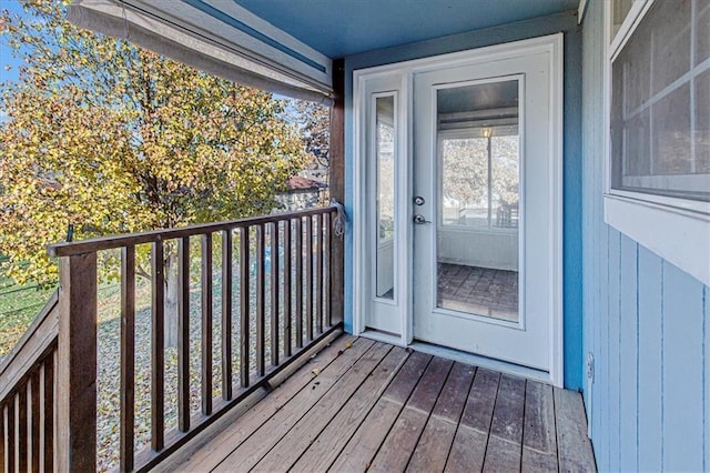 view of exterior entry with a balcony