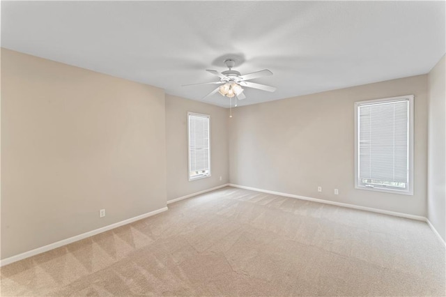 unfurnished room with light colored carpet and ceiling fan