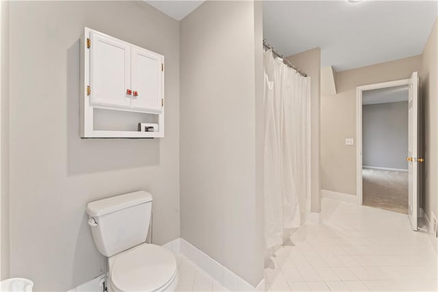 bathroom featuring toilet and tile patterned floors