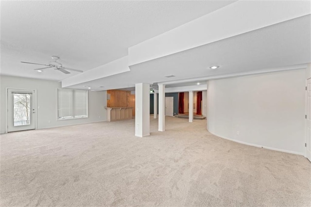 unfurnished living room with ceiling fan and light carpet