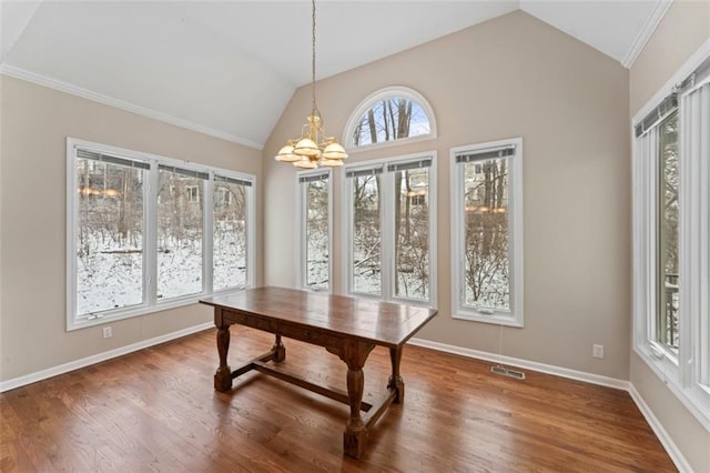 office space with hardwood / wood-style floors, lofted ceiling, and a notable chandelier