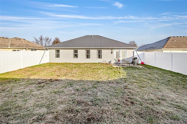 back of house featuring a yard and a patio area