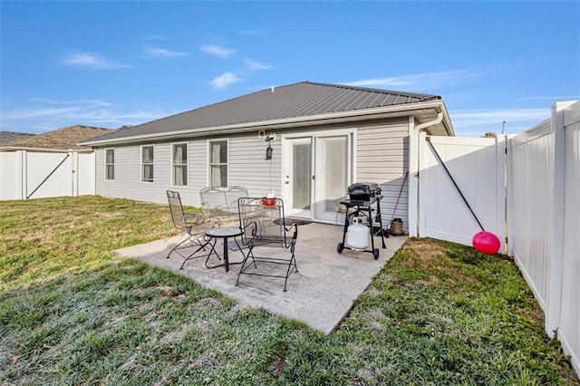 rear view of property featuring a yard and a patio