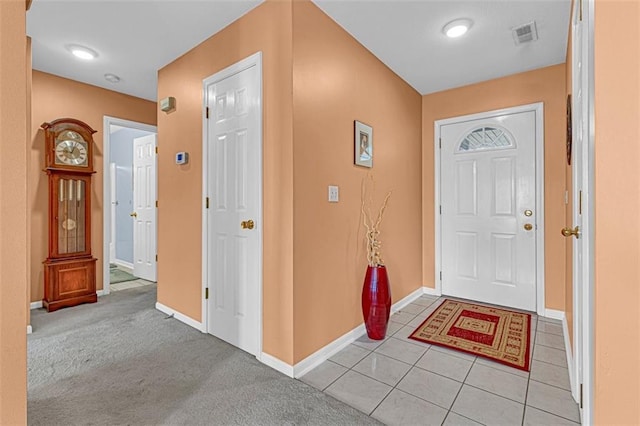 view of carpeted foyer entrance