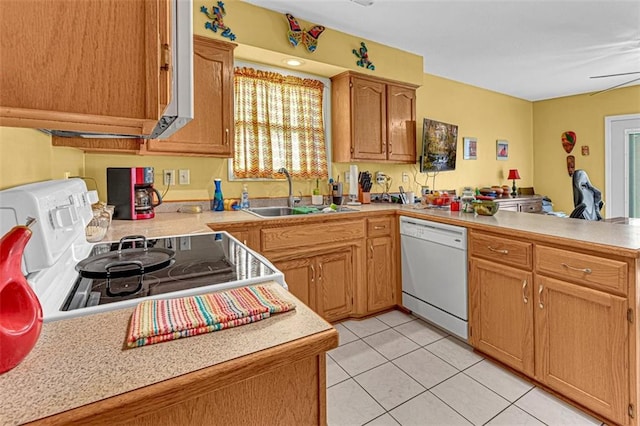 kitchen with dishwasher, sink, kitchen peninsula, light tile patterned flooring, and range