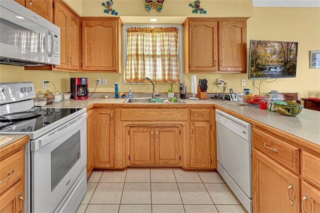 kitchen with light tile patterned flooring, white appliances, and sink