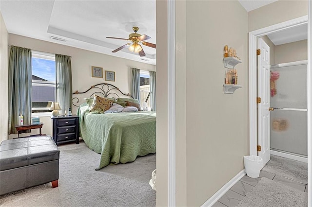 bedroom with ceiling fan and light carpet