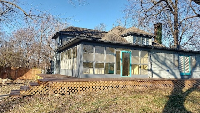 back of house with a wooden deck and a sunroom