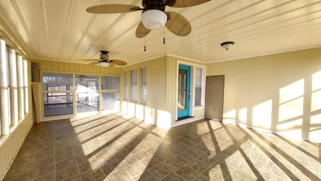 unfurnished sunroom featuring ceiling fan