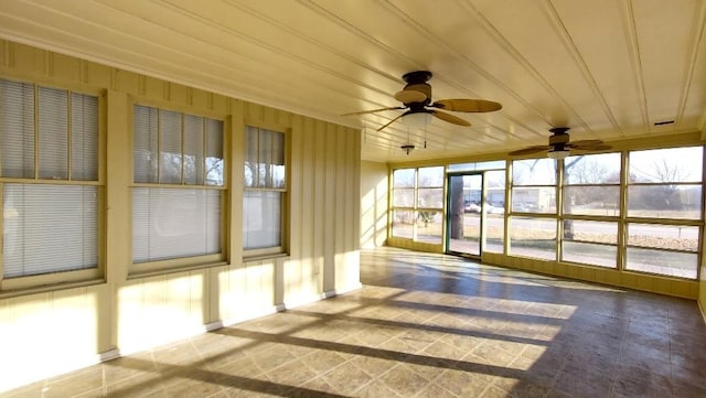 unfurnished sunroom featuring ceiling fan