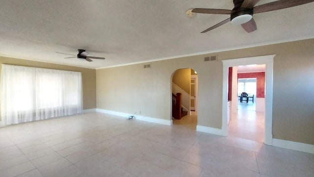 spare room with ceiling fan and crown molding