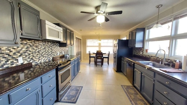 kitchen featuring sink, plenty of natural light, decorative light fixtures, and appliances with stainless steel finishes