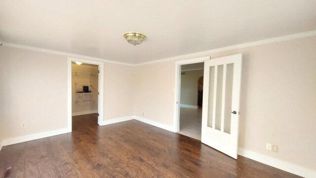 unfurnished room with dark hardwood / wood-style floors and crown molding