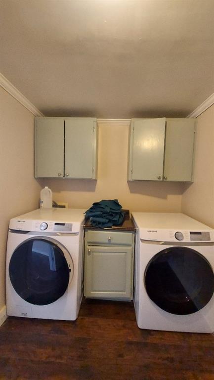 laundry area with cabinets, dark hardwood / wood-style floors, washer / dryer, and ornamental molding