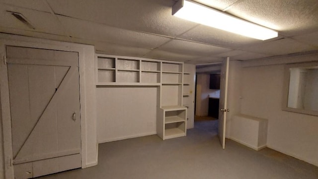 interior space with a paneled ceiling