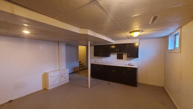 basement with light colored carpet and sink