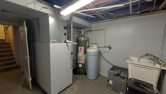 utility room featuring water heater