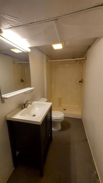 bathroom featuring vanity, toilet, and walk in shower