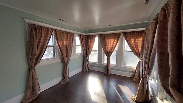 unfurnished room with dark wood-type flooring