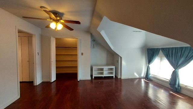 additional living space featuring ceiling fan, lofted ceiling, and dark wood-type flooring