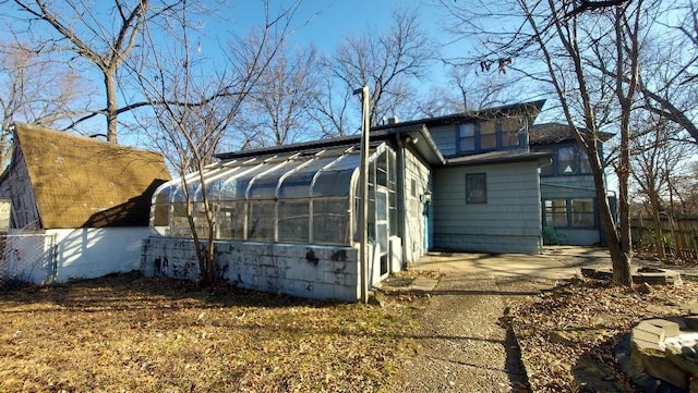 view of home's exterior with a sunroom