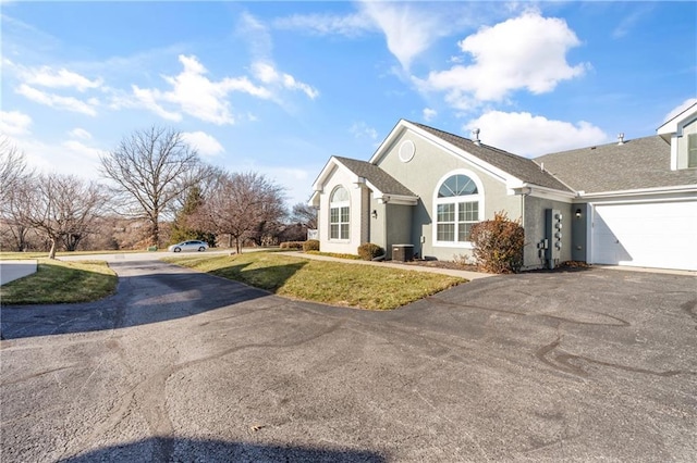 view of front of house with a garage and a front lawn