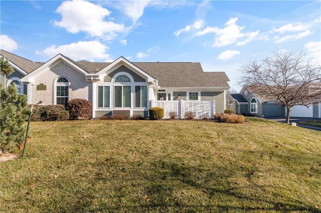 ranch-style home featuring a front yard