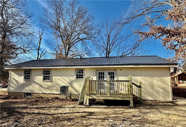 back of property with french doors, a deck, and cooling unit