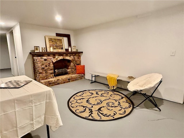 bedroom featuring a brick fireplace and concrete floors