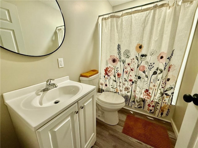 full bathroom with vanity, wood-type flooring, toilet, and shower / bath combo with shower curtain