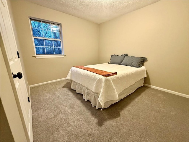 bedroom featuring carpet floors and a textured ceiling