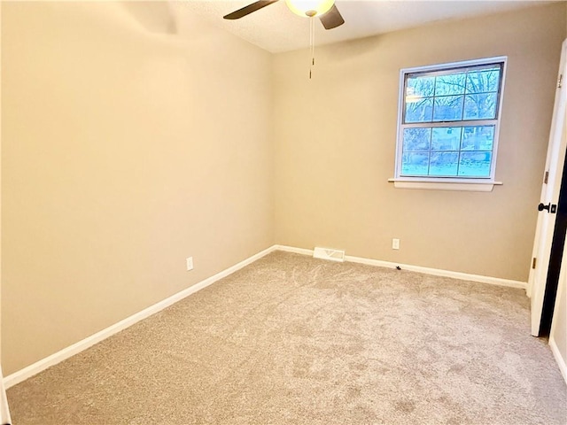 carpeted empty room featuring ceiling fan