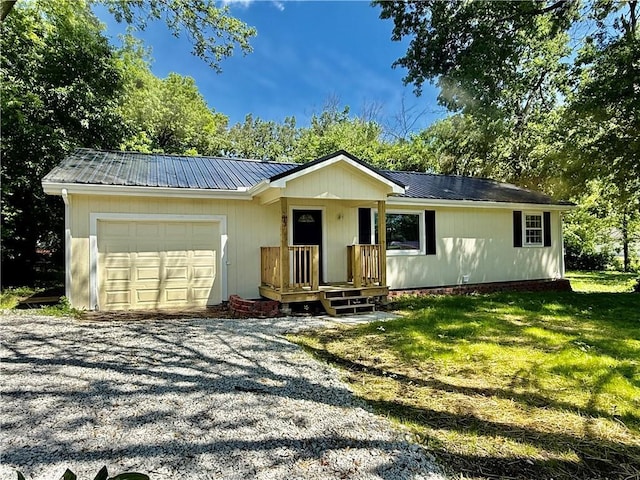 513 S Thornton St, Richmond, MO 64085 - single story home featuring a garage, metal roof, driveway, and a front lawn