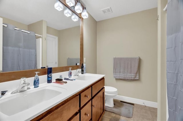 bathroom featuring tile patterned floors, vanity, curtained shower, and toilet